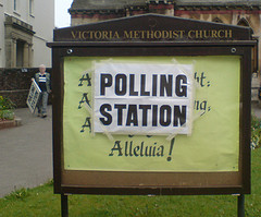 Church sign with a temporary Polling Station sign on it but the word Alleluia is still visible